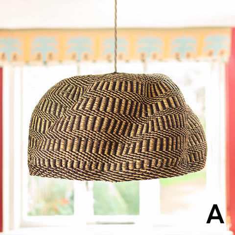 Handwoven large colourful basket pendant light made from natural elephant grass with intricate zigzag pattern hanging indoors