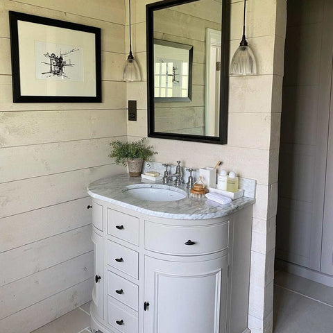 The Strand Bathroom prismatic glass pendant light in a small size above a white marble bathroom vanity