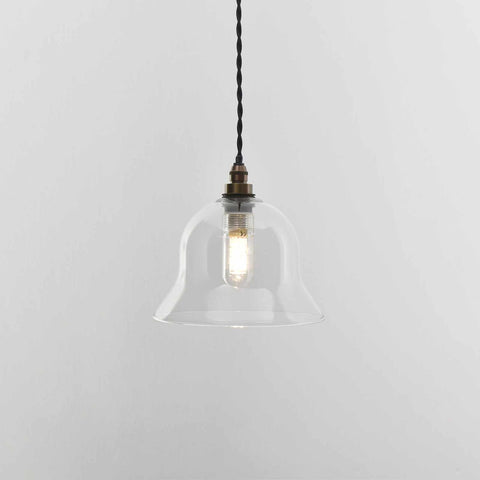Small clear glass bathroom pendant light with adjustable flex, ideal for compact spaces.