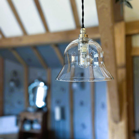 Small clear glass shade bathroom pendant light with adjustable flex, handcrafted in England; ideal for compact spaces and wet environments.