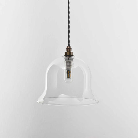 Bathroom pendant light with a medium clear glass shade.
