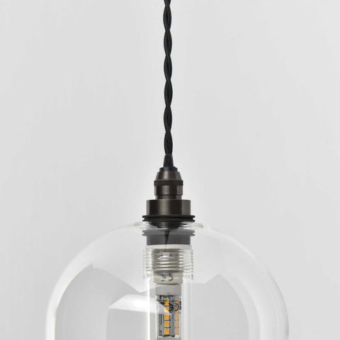 Bathroom pendant light with clear glass shade and adjustable black twisted cord, modern elegant design