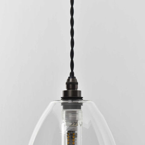 Camber Medium Clear Glass pendant light with adjustable black cord and clear glass shade for bathroom lighting