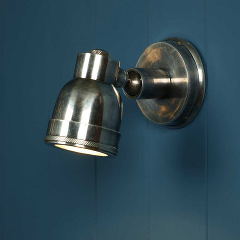 Henton Bathroom Adjustable Spotlight in antique silver with swivel joint mounted on blue wall