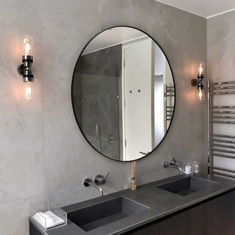 Aldbury Bathroom Double Wall Light in modern bathroom setting with round mirror and gray tiles.