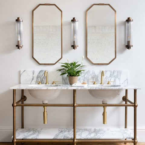 Louise Bathroom Wall Light with art deco reeded glass mounted beside two mirrors above double marble sink vanity