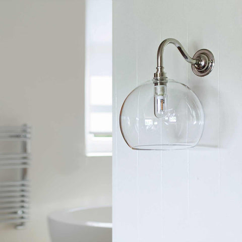 Soho Medium Clear Glass Shade bathroom wall light with curved swan neck and clear glass globe mounted on white wall