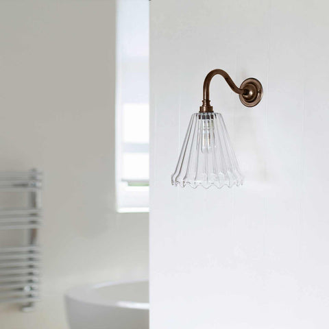 Rye small ribbed glass shade bathroom wall light with vintage frilled design and bronze fixture mounted on white wall