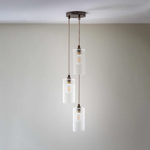 Brook Small Ribbed Glass Shade cluster pendant light with three hand-blown frosted glass shades and metal fixtures hanging from ceiling