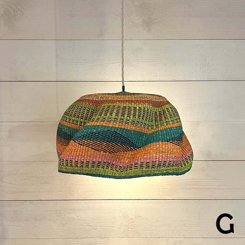 Woven colourful basket pendant light made from natural elephant grass with vibrant stripes and handcrafted design