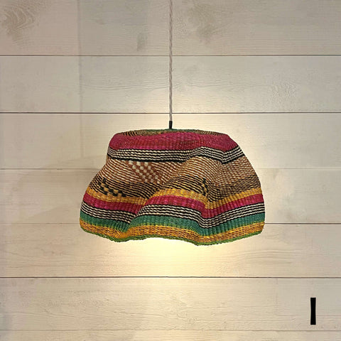 Woven colourful basket pendant light made from natural elephant grass with vibrant stripes hanging on a cord