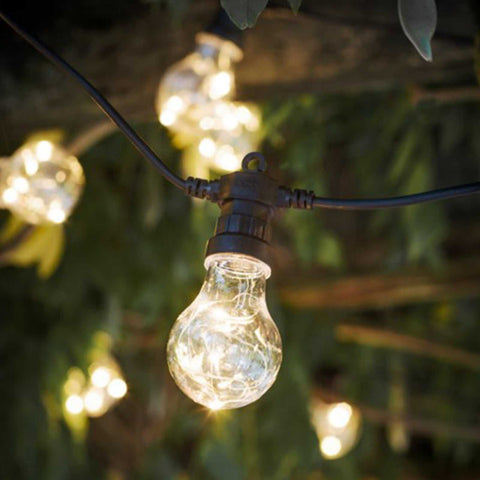 Classic Festoon 20 Bulbs outdoor string lights glowing warmly in a garden setting