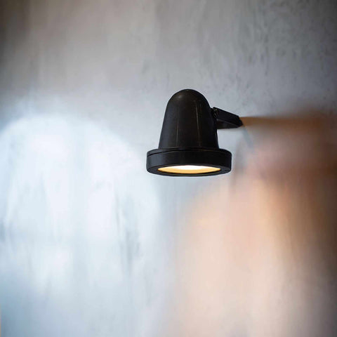 Thames Outdoor Spot Light in matte black mounted on wall illuminating soft light