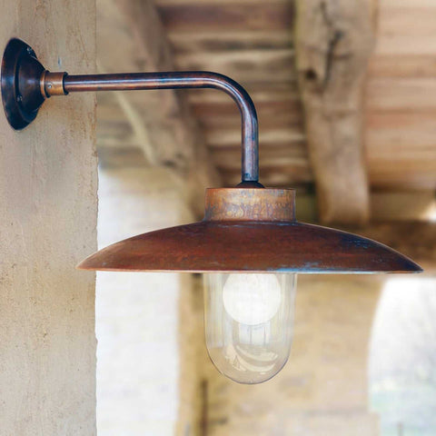 Large Nabucco outdoor wall light in aged copper and brass with clear glass shade, ideal for patios and exterior lighting.
