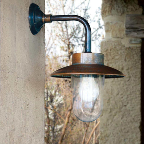 Nabucco Outdoor Wall Light small aged copper and brass finish mounted on outdoor wall near stone background