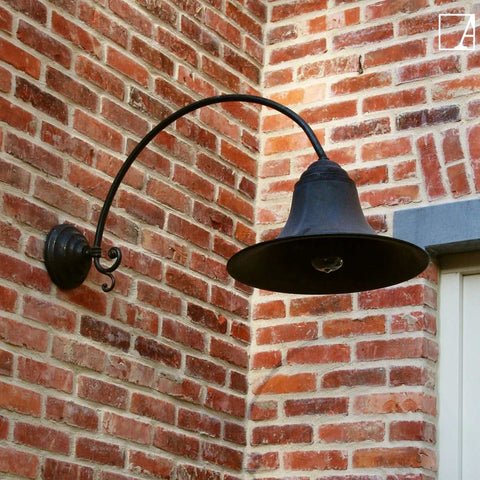 Kew Outdoor Wall Light large bronze curved arm mounted on brick exterior wall illuminating outdoor space