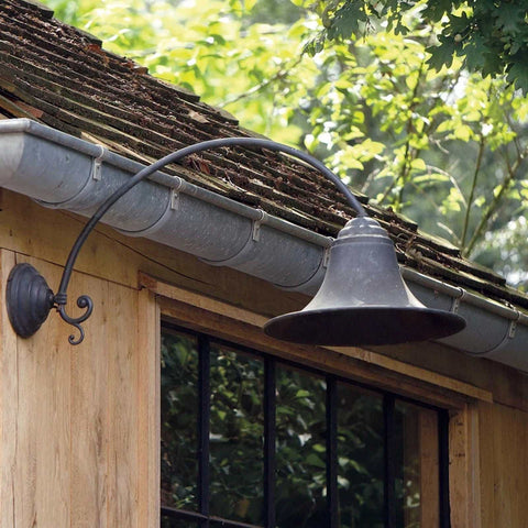 Kew Outdoor Wall Light large bronze curved design mounted on wooden exterior wall under roof gutter
