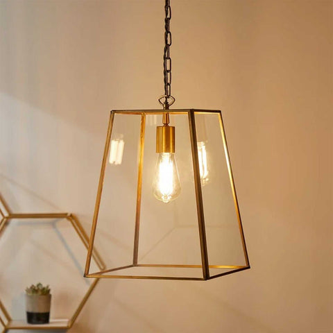 Large Luxor Lantern Pendant Light with clear glass panels and antique brass frame hanging from chain ceiling fixture