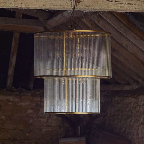 Modern Loki Two-Tiered Oval Chandelier pendant light with brass frame and glass rods hanging from ceiling