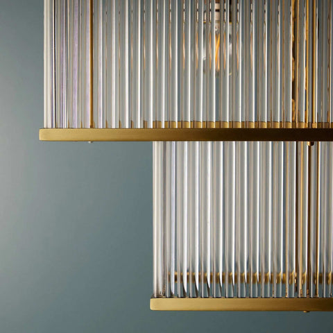 Close-up of Odin Chandelier showcasing handcrafted glass rods and golden brass frame details