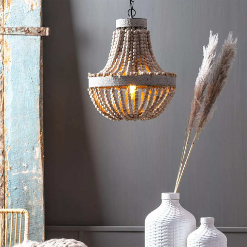 Small Luna Wooden Ceiling Pendant Light with hand-tied wooden beads in a shabby chic style hanging above white vases with dried pampas grass