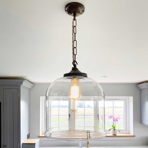 Hythe large clear glass shade pendant light with exposed bulb hanging in modern kitchen interior