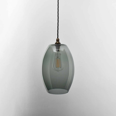 Camber large smoked glass shade pendant light with vintage bulb and black twisted cord hanging against white background