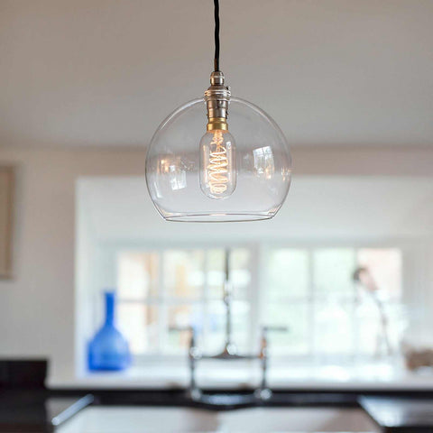 Soho medium clear glass shade pendant light with filament bulb hanging in modern kitchen