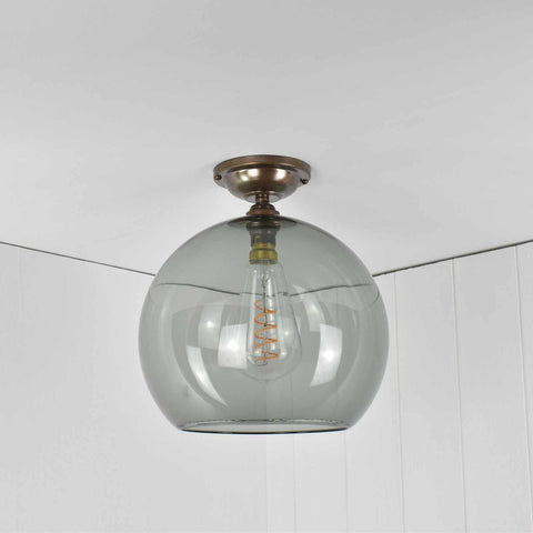 Large Soho smoked glass shade flush ceiling light with visible filament bulb and brass fittings