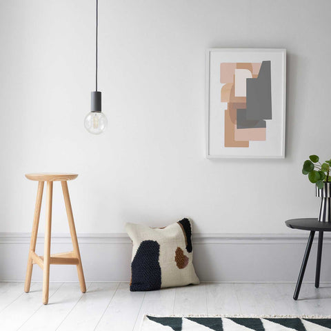 Modern Scandi Simple Bulb Pendant Light hanging in a minimalist room with wooden stool, abstract wall art, and cushion on white wooden floor