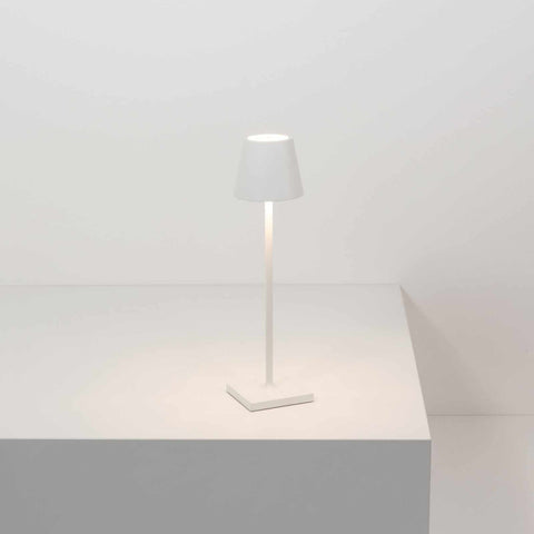 Zafferano Poldina Micro rechargeable white LED table lamp on minimalist white surface