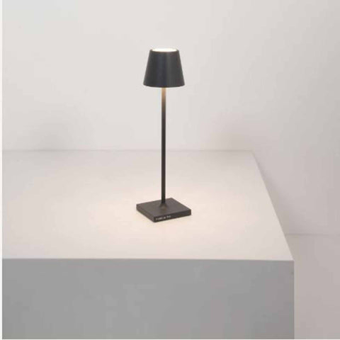 Zafferano Poldina Micro rechargeable grey table lamp with sleek, compact design on table