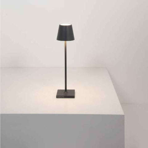 Zafferano Poldina Micro grey rechargeable LED table lamp with sleek modern design on white surface