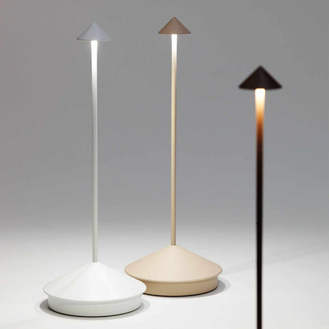 Three Zafferano Pina Pro rechargeable sand table lamps in white, beige, and black with modern cone-shaped design and adjustable brightness.