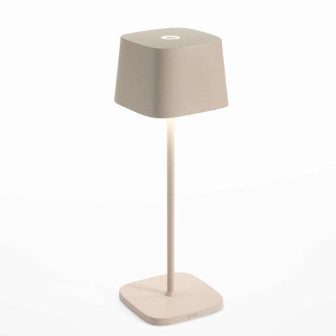 Zafferano Ofelia Pro rechargeable table lamp with modern contact charging base, touch dimmer control, and adjustable color temperatures for personalized lighting.