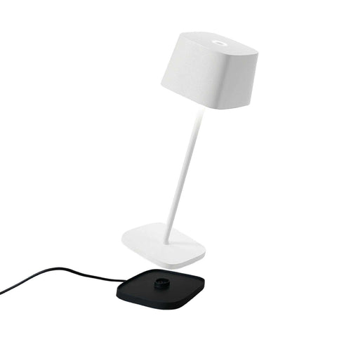 Zafferano Ofelia Pro rechargeable white table lamp with modern contact charging base and touch dimmer control