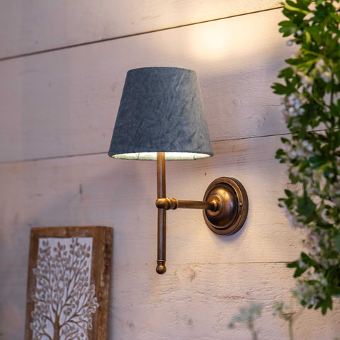 Finberry Fabric Shade Lupin wall light with blue fabric shade and bronze fitting mounted on white wooden wall