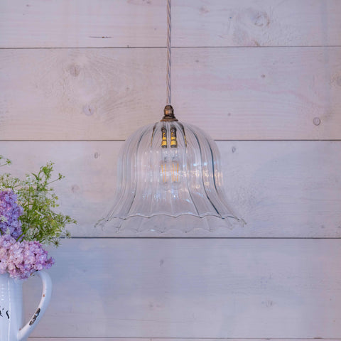 Bodium Large Ribbed Glass Shade Pendant Light with clear ribbed glass and adjustable cord hanging in rustic interior