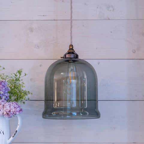 Hythe Medium Smoked Glass Shade pendant light with adjustable flex and smoky grey glass shade hanging in a modern room.