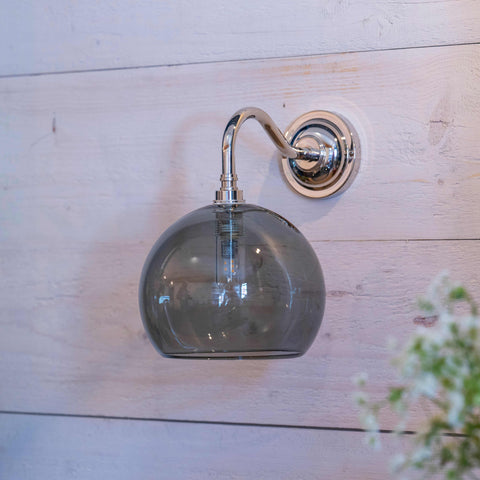 Soho medium smoked glass shade bathroom wall light with chrome arm on wooden wall