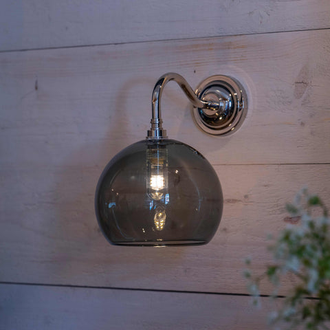 Soho medium smoked glass shade bathroom wall light with chrome fixture mounted on wooden wall