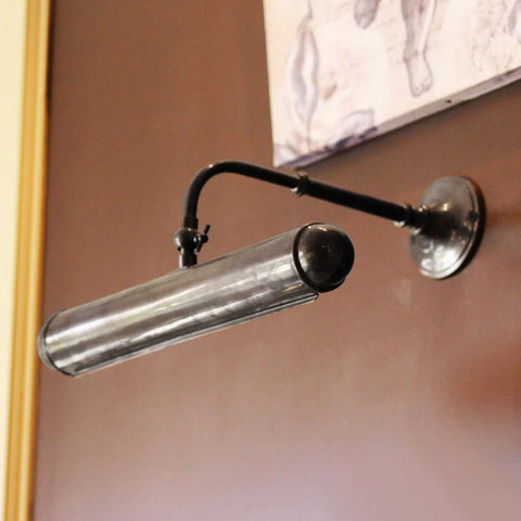 Dulwich Picture Light handcrafted adjustable wall light with sleek metal finish illuminating artwork