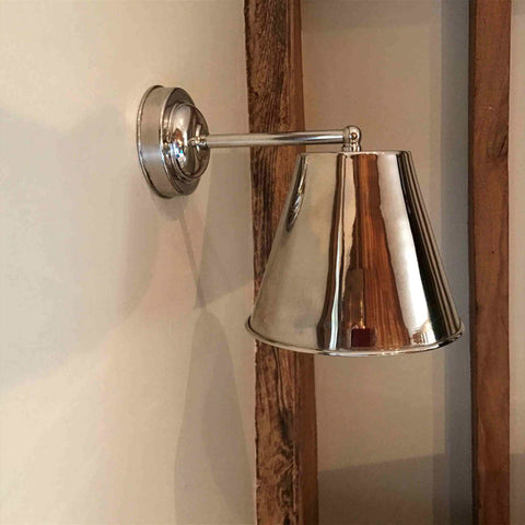 Large Henley Bell Wall Light in polished nickel, solid brass bell-shaped industrial style wall light mounted on a wooden beam and beige wall.