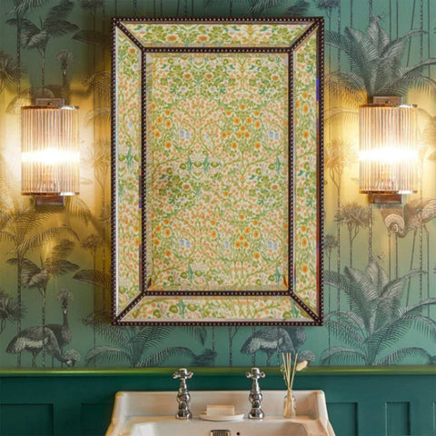 Pooky Roddy Wall Light with clear glass rods in brass finish flanking a floral patterned mirror in a vintage bathroom setting