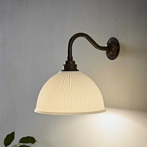 Denton Medium Ribbed Ceramic Shade Wall Light with soft diffused lighting and dark curved arm