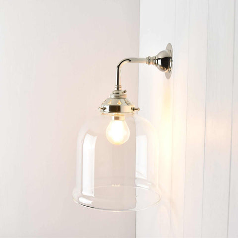 Hythe Small Clear Glass Shade Wall Light with polished metal mount illuminating interior space