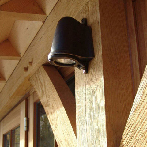 Bourne Outdoor Mast Light in bronze finish mounted on wooden exterior beam for outdoor lighting