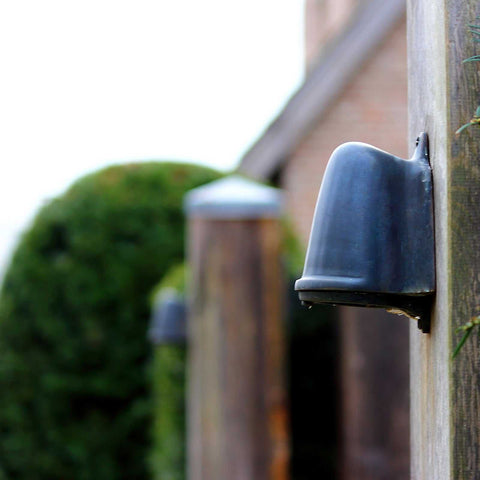 Bourne Outdoor Mast Light in black finish mounted on wooden pole for outdoor pathway lighting