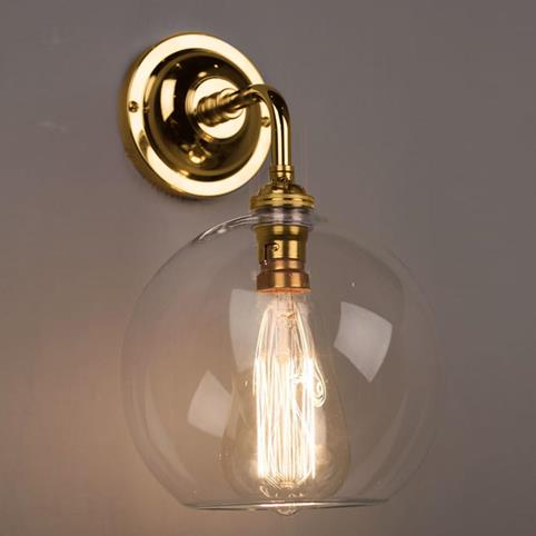 LENHAM Contemporary Wall Light with Clear Glass Shade in Polished Brass