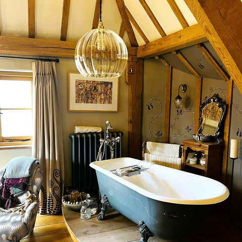 Elegant bathroom with bespoke wall sconces and clear glass lighting fixtures from a bathroom lighting collection